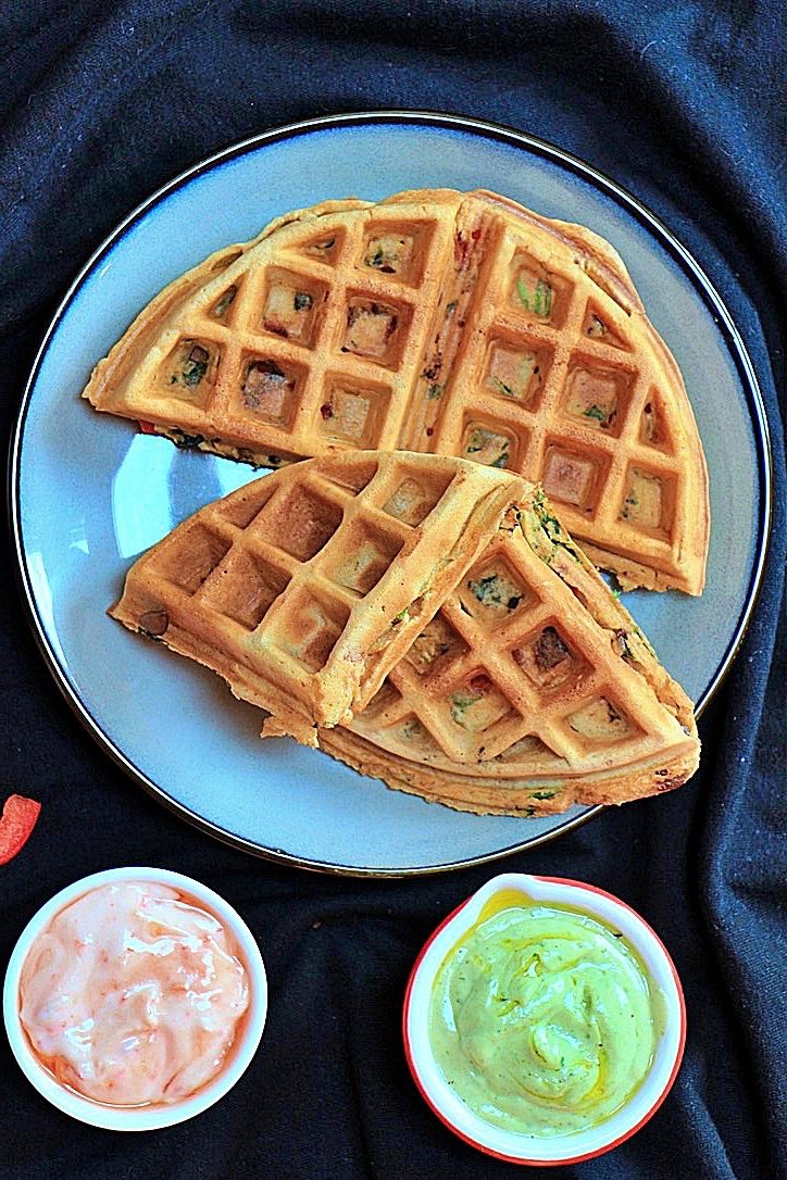 Savoury waffles plated with sauces