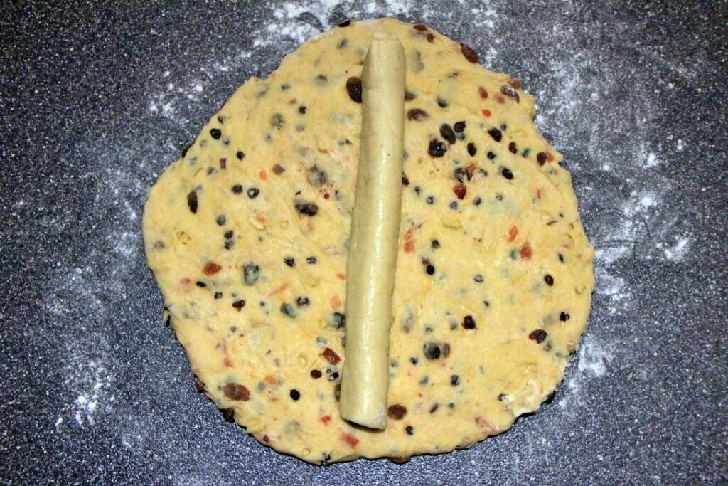 Rolled out dough with marzipan for stollen