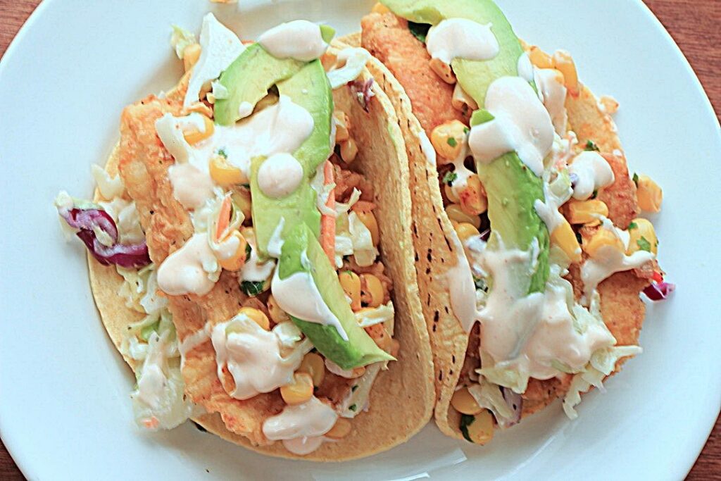 Fish taco with coleslaw and corn