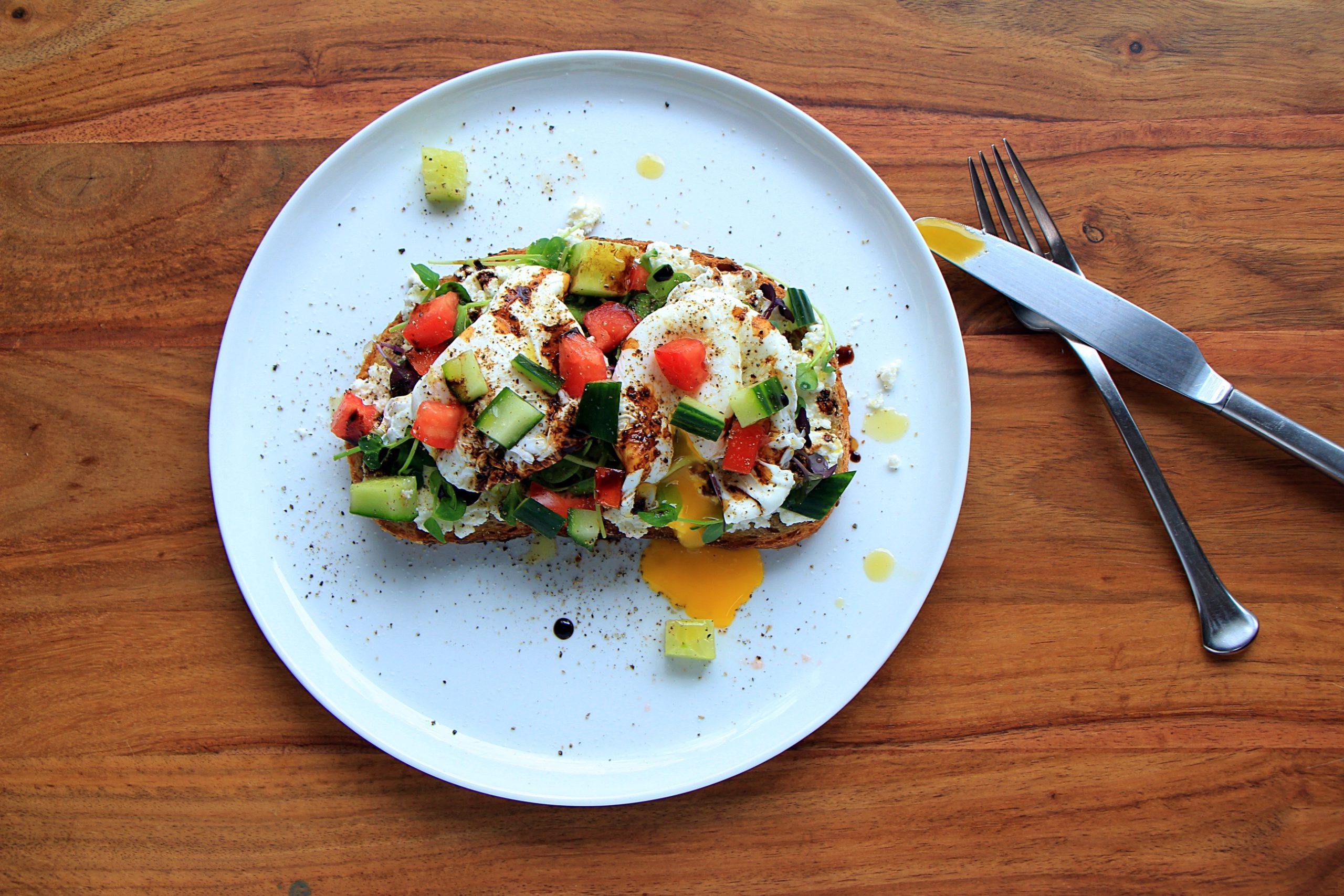 Mediterranean breakfast toast with whole poached eggs