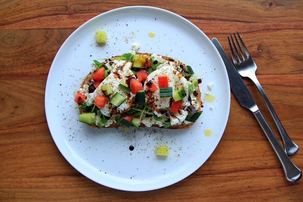 Mediterranean breakfast toast with whole poached eggs